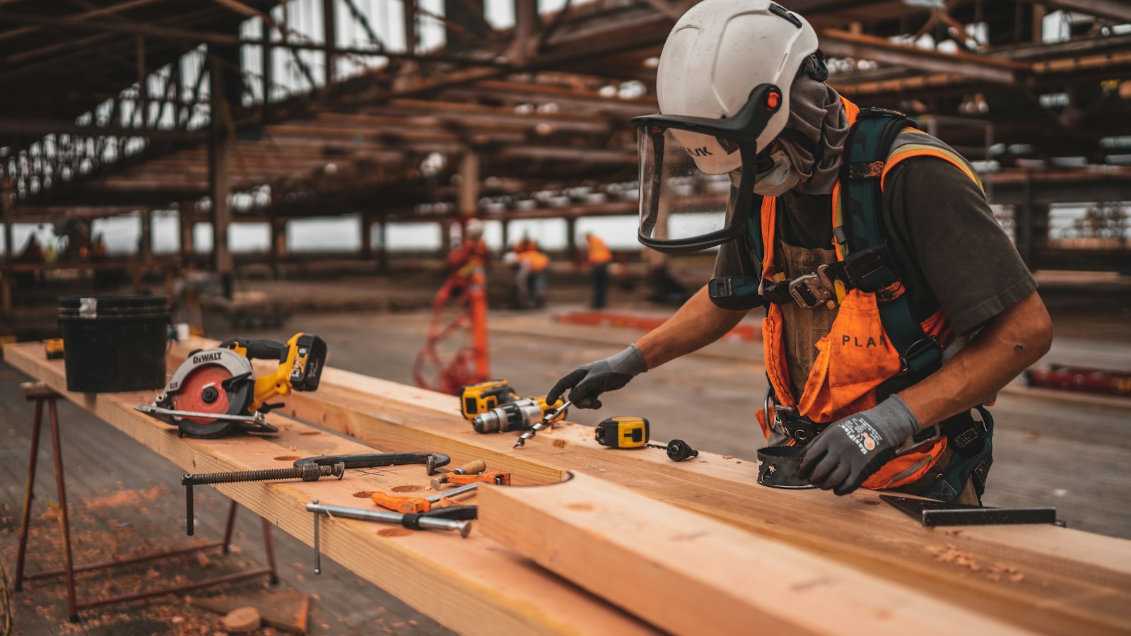 Carpenter measuring and preparing timber with professional tools