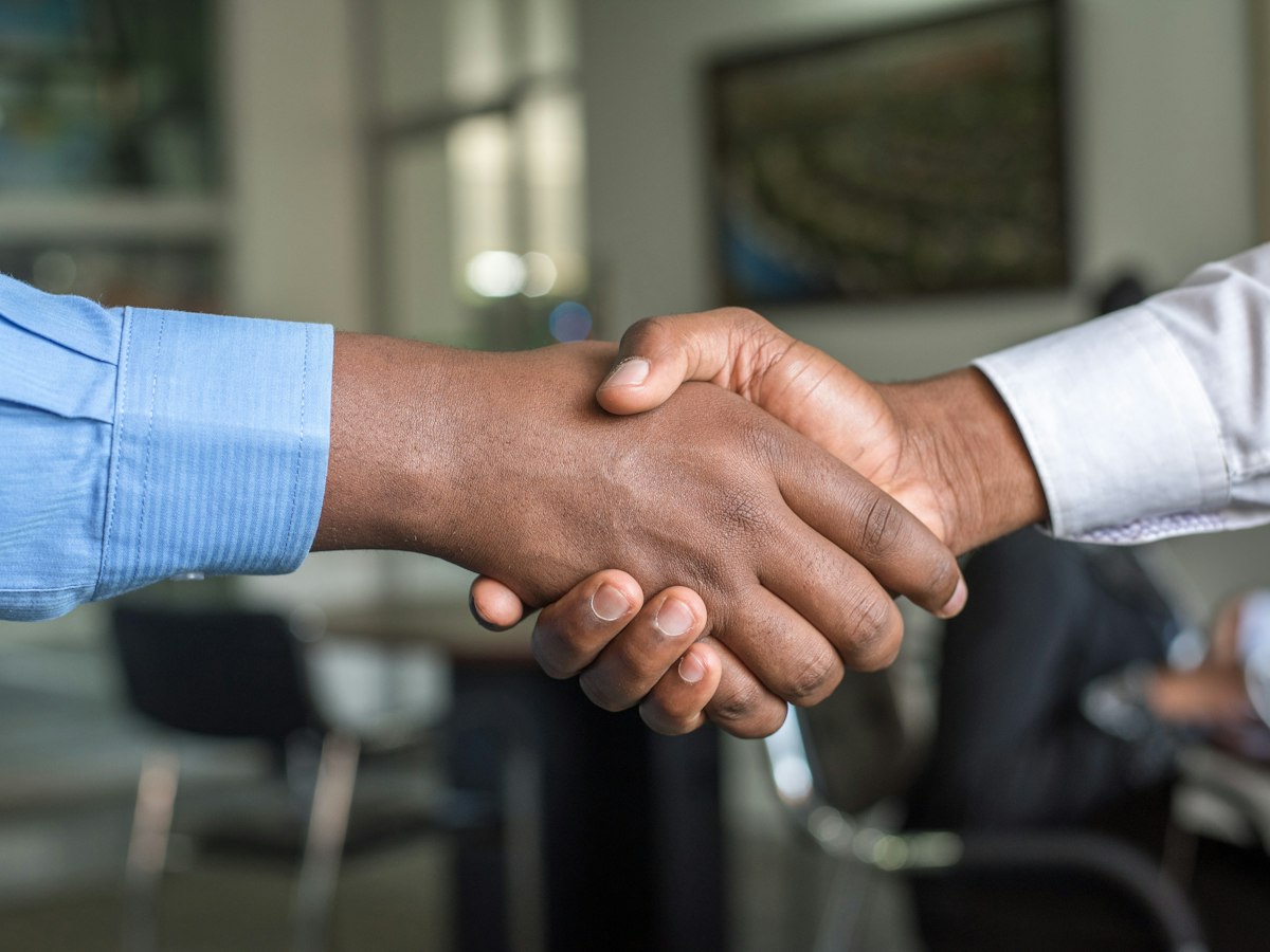 Employer and recruitment representative shaking hands after a meeting