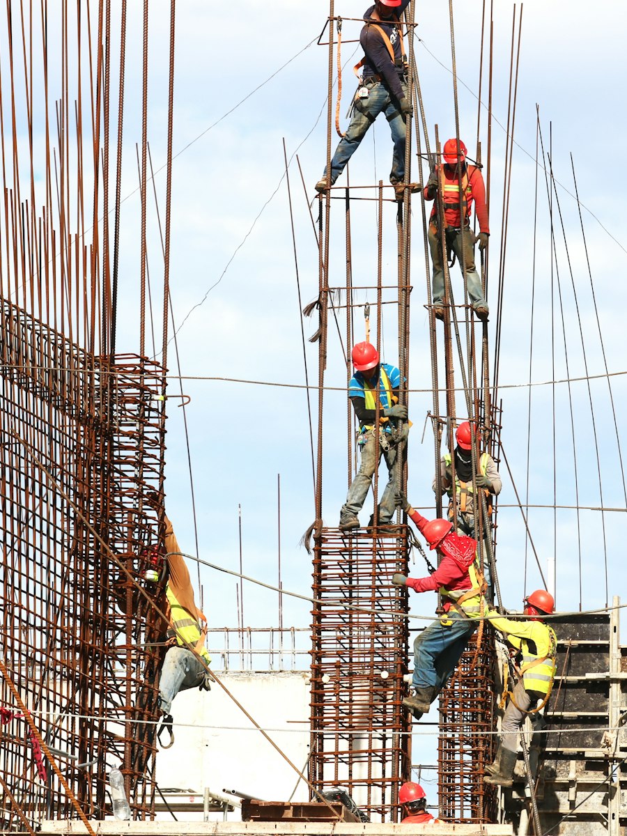 Workers on a construction site installing steel reinforcement